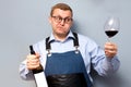 Male sommelier is checking and testing red wine