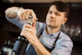 Male sommelier open wine bottle with corkscrew. Royalty Free Stock Photo