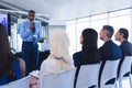 Male speaker with digital tablet speaks in business seminar Royalty Free Stock Photo