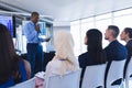 Male speaker with digital tablet speaks in business seminar Royalty Free Stock Photo