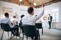 Male speaker giving presentation in hall at workshop. Audience or conference hall. Rear view of unrecognized Royalty Free Stock Photo