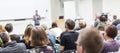 Man giving presentation in lecture hall at university.