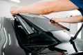Male specialist with car tinting film in hands Royalty Free Stock Photo