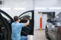 Specialist installs wetted car tinting, tuning Royalty Free Stock Photo