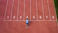 Male sprint runner alone on the athletic track, aerial above shot