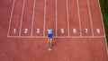 Male sprint runner alone on the athletic track, aerial above shot