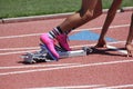 Male sprinter in starting block pink shoes