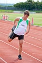 Male sprinter stretching before a race