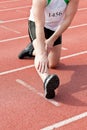 Male sprinter warming up