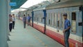 Male staff members of railway company waiting on platform for train's departure.