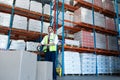 Male staff using pallet jack in warehouse Royalty Free Stock Photo