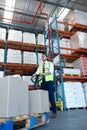 Male staff using pallet jack in warehouse Royalty Free Stock Photo