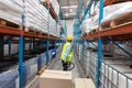 Male staff using pallet jack in warehouse Royalty Free Stock Photo