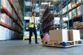 Male staff using pallet jack in warehouse Royalty Free Stock Photo