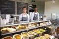 Male Staff Working Behind Counter In Delicatessen