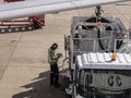 A male staff writing bill of fuel used of the aircraft. Aircraft engineer working on refueling.