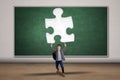 Male student carrying a puzzle Royalty Free Stock Photo