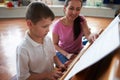 Male Student Enjoying Piano Lesson With Teacher Royalty Free Stock Photo