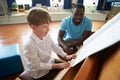 Male Student Enjoying Piano Lesson With Teacher Royalty Free Stock Photo