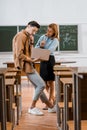 Male student and female teacher using laptop during lesson Royalty Free Stock Photo