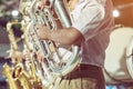 Male student with friends blow the euphonium with the band for performance on stage Royalty Free Stock Photo