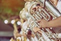 Male student with friends blow the euphonium with the band for performance on stage Royalty Free Stock Photo