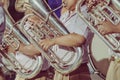 Male student with friends blow the euphonium with the band for performance on stage