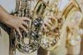 Male student with friends blow the saxophone with the band for performance on stage Royalty Free Stock Photo