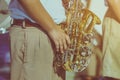 Male student with friends blow the saxophone with the band for performance on stage Royalty Free Stock Photo