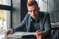 Male student hipster reading a book. Knowledge, education, development concept Royalty Free Stock Photo