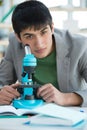 Male student in laboratory working with microscope Royalty Free Stock Photo