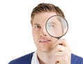 Male student looking through a magnifying glass Royalty Free Stock Photo