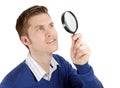 Male student looking through a magnifying glass Royalty Free Stock Photo
