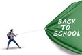 Male student pulling banner of back to school Royalty Free Stock Photo