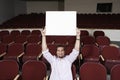Male Student Raising Sign Board While Sitting In Classroom Royalty Free Stock Photo