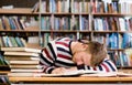 Male student sleeping in library Royalty Free Stock Photo