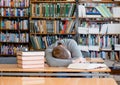 Male student sleeping in library Royalty Free Stock Photo