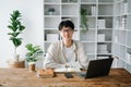 Male student taking notes from a book at library, Young asian sitting at desk doing assignments in college library Royalty Free Stock Photo