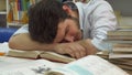 Male student wakes up at the library