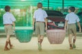 Male Students help to remove rubbish from the classroom