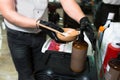 Male Stylist in gloves preparing color cream for dying hair container, a mask for treatment procedure in beauty salon. Hairdresser