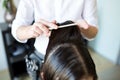 Male stylist hands combing wet hair at salon