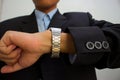 Male suit business staring wristwatch