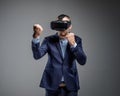 Male in a suit fighting with virtual reality glasses on his head
