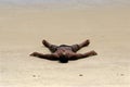 Male sunbather on sand beach in Brazil