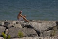 Sunbather on boulders Royalty Free Stock Photo