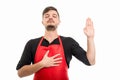 Male supermarket employer making oath gesture