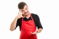 Male supermarket employer showing calling gesture