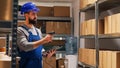 Male supervisor scanning barcodes on packages in depot