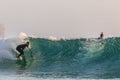 Male surfer doing tricks taking over the strong waves of the ocean in Algarve, Portugal